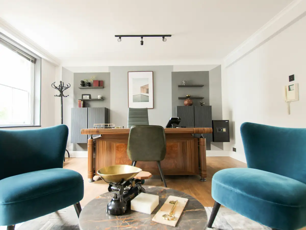 Professional consultation workspace with notebooks and two chairs